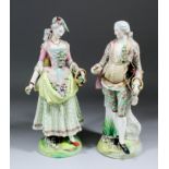 A pair of 19th Century Continental porcelain candelabra figures of a gentleman and a lady in 18th