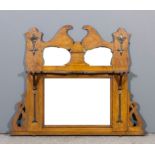 An early 20th Century oak oval mantel mirror in the Arts & Crafts style with scroll cresting and