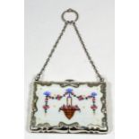 A George V silver and enamel rectangular aide memoire/purse of shaped outline and with scroll