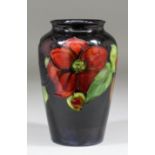 A Moorcroft pottery baluster shaped vase tube lined and decorated in colours with a "Clematis"