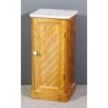 A late Victorian satin walnut bedside cabinet with white flecked marble slab to top enclosed by a