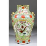 A Chinese "Cantonese" porcelain two-handled vase painted in panels with prunus, chrysanthemums and