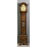 A 1920s dark oak "Grandmother" clock, the 8ins arched brass dial with silvered chapter ring with