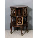 A late Victorian mahogany and gilt brass circular revolving bookcase with moulded edge to top, the