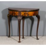 A 1920s figured walnut semi-circular card table of "Queen Anne" design, the baize lined folding