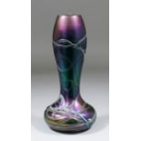 A late 19th Century iridescent glass vase in the "Loetz" manner with baluster neck and bulbous base,