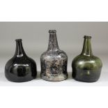 Three early 18th Century wine bottles - Dark green/brown glass onion shaped bottle, the narrow