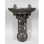 A 19th Century French bronze clock bracket cast with Renaissance ornament and the head of a