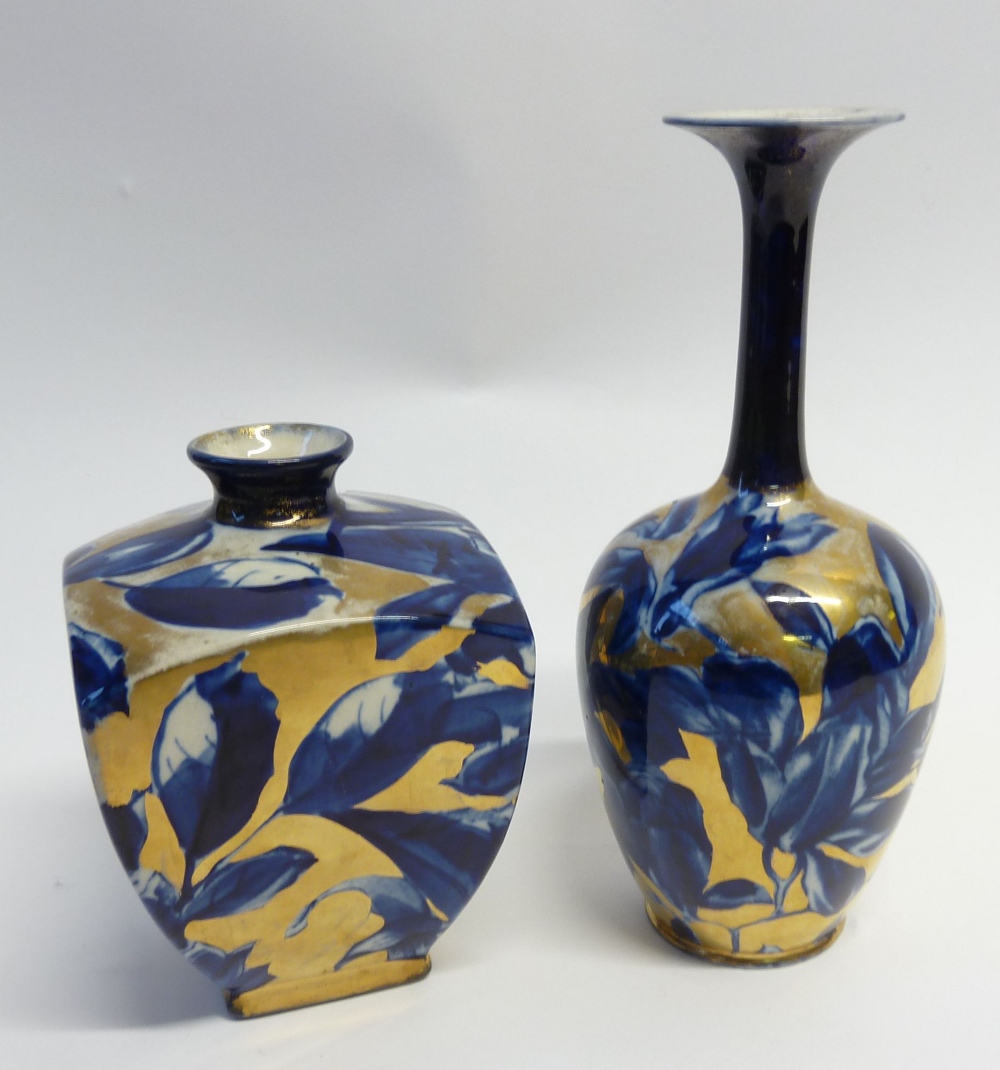 TWO LATE 19th CENTURY BOOTHS POTTERY VASES, both decorated with blue flowers on gilt ground, one