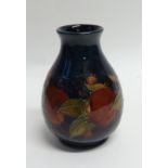 WILLIAM MOORCROFT 'POMEGRANATE' PATTERN TUBE LINED POTTERY VASE, of footed baluster form with