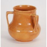 *ASHTEAD POTTERY THREE HANDLED VASE, footed baluster form with angular handles, buff glazed, 6" (