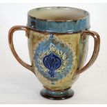 EARLY TWENTIETH CENTURY ROYAL DOULTON MOULDED POTTERY THREE HANDLED TYG, footed, tapering form