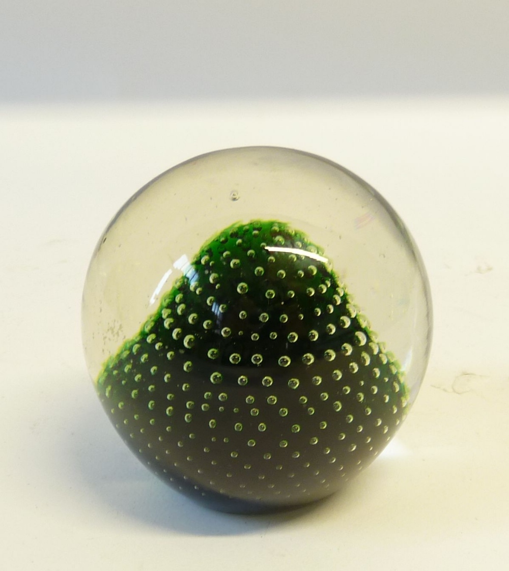 HOLMEGAARD, DANISH GLASS PAPERWEIGHT with clear glass on a green domed ground, 3" (7.6cm) high,