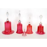 FOUR NINETEENTH CENTURY CRANBERRY GLASS BELLS, including one with vaseline glass rim AND A SMALLER