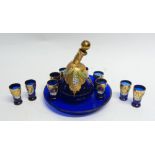 EARLY TWENTIETH CENTURY BOHEMIAN FLORAL ENCRUSTED BLUE GLASS AND GILT DRINKS SET FOR TEN PERSONS,