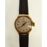 LADIES RECORD, 9CT GOLD CASED WRIST WATCH, 15 jewel movement, silvered arabic dial, on black leather
