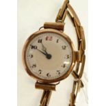 LADIES 9CT GOLD CASED WRIST WATCH, mechanical movement, with white porcelain arabic dial, on