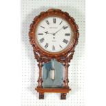 WALDVOGEL, BURY, LATE NINETEENTH CENTURY CARVED WALNUTWOOD DROP DIAL WALL CLOCK, the 12" enamelled