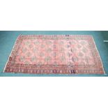 TURKOMAN BOKHARA RUG.  With three rows of guls on a wine red field with abrash, three narrow  border