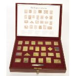 'THE EMPIRE COLLECTION', A CASED SET OF 25 SILVER-GILT 'POSTAGE STAMP' MEDALLIONS, 15g all in