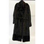 A LADY'S SUPERB BLACK MINK FULL LENGTH FUR COAT, with short revered collar, fastening as a high