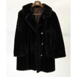 A LADY'S BLACK BEAVER LAMB 3/4 LENGTH COAT with revered collar, three button front, half belted back