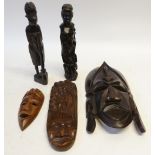 TWO AFRICAN CARVED EBONY FIGURES, 12 1/2" (31.8cm) high, together with a SIMILAR OBLONG PANEL, 15