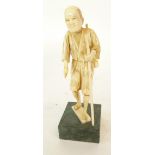 JAPANESE MEIJI PERIOD CARVED SECTIONAL IVORY OKIMONO, modelled as an elderly man carrying a staff, 7