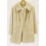 A LADY'S  CREAM COLOURED CONY FUR 3/4 LENGTH COAT with revered collar, double breasted front with