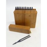 A SET OF 12 TUNING FORKS, C'-B (C" missing) in wooden case
