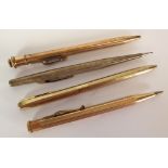 ENGINE TURNED STERLING SILVER CASED RETRACTABLE PENCIL AND THREE OTHERS in rolled gold (4)