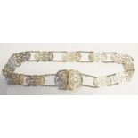 EDWARDIA NLADIES SILVER BELT comprising eleven cut card pierced and floral engraved shaped oblong
