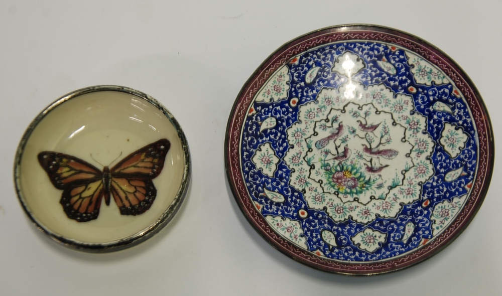 A PERSIAN ENAMELLED ON METAL SMALL CIRCULAR PLAQUE, intricately decorated with birds on a