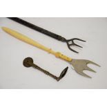 AN ANTIQUE BRASS PASTRY CUTTING WHEEL wit leaf shaped pattern maker top, an old metal BREAD FORK,