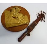 CAST GILT METAL PLAQUE OF NAPOLEON BONAPARTE CROSSING THE ALPS, mounted onto teak circular plaque, 9