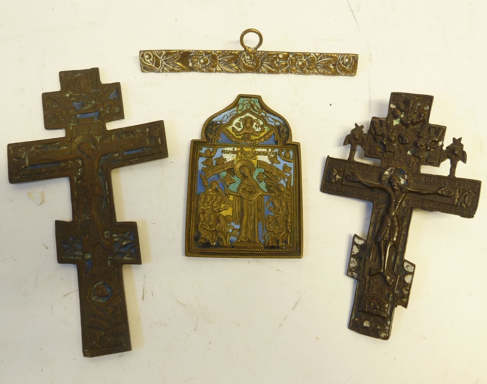 *THREE CAST BRASS 'BRONZED' AND ENAMELLED DEVOTIONAL CRUCIFIXES AND ICON AND ANOTHER ITEM OF CAST