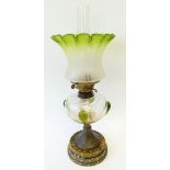 VICTORIAN POTTERY AND GLASS TABLE OIL LAMP, with mottled green and yellow pottery circular base,