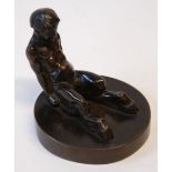 DARK BROWN PATINATED FIGURE OF A SATYR, seated with legs spread on a circular base, 2 3/4" (7cm)