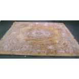 WASHED CHINESE EMBOSSED CARPET of Aubusson design, having gold ground, fawn and brown floral oval