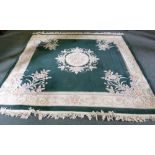 A SUPER WASHED AND HAND KNOTTED EMBOSSED CHINESE ALL WOOL CARPET with plain dark green field and