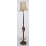 EARLY TWENTIETH CENTURY GILT METAL STANDARD LAMP, with ornately cast column and raised on a