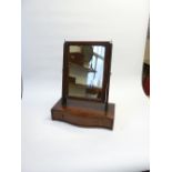 NINETEENTH CENTURY MAHOGANY SERPENTINE FRONTED TOILET MIRROR, the oblong plate, in a moulded