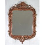 AN EARLY VICTORIAN PAINTED AND PARCEL GILDED CARTOUCHE SHAPE WALL MIRROR, the repealed glass