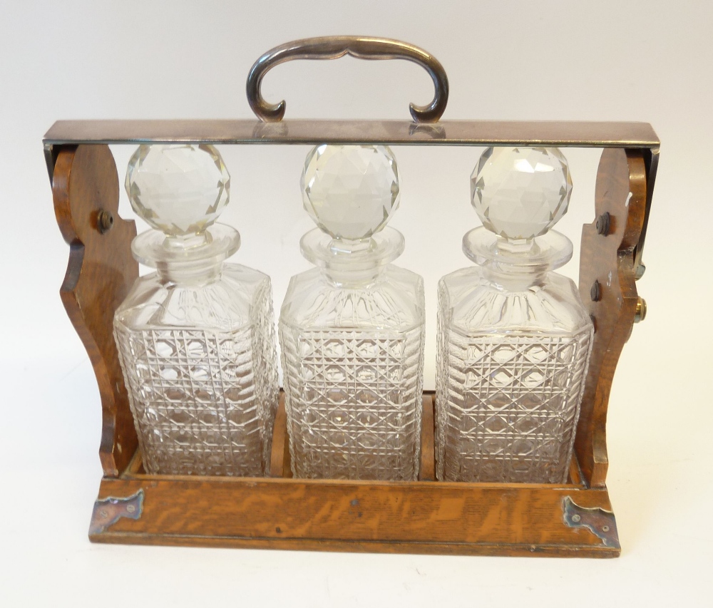 BETJEMANNS PATENT OAK TANTALUS, with electroplated mounts WITH THREE CUT GLASS DECANTERS, 14" x