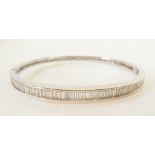 DIAMOND SET 18CT WHITE GOLD HINGE OPENING BANGLE, channel set with 55 slightly graduated baguette