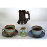 SIX PIECES OF PINKNASH POTTERY COMPRISING; black glazed  TANKARD, with rampant lion pattern