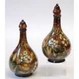 PAIR OF DOULTON LAMBETH FAIENCE POTTERY BOTTLE VASES, with stoppers, painted in tones of green,