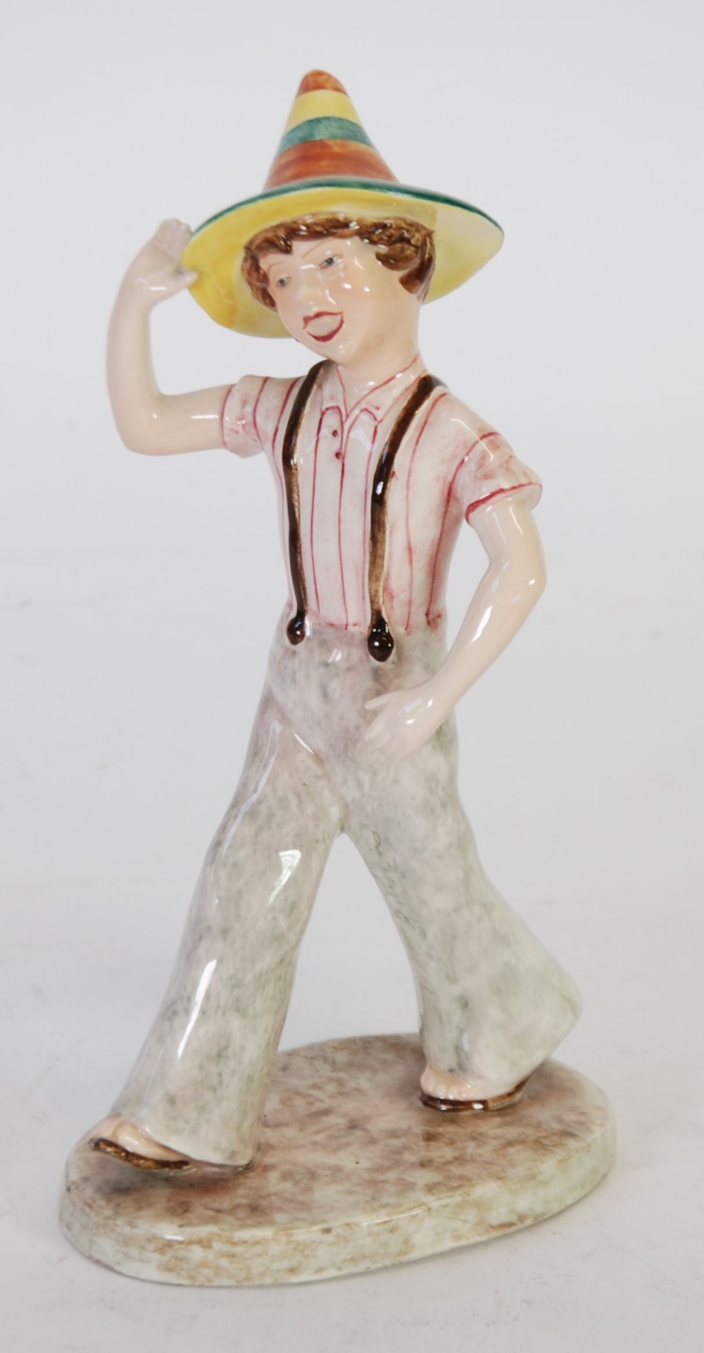 LATE GOLDSCHEIDER POTTERY FIGURE modelled as a striding boy wearing a conical hat, 9" (22.8cm) high,