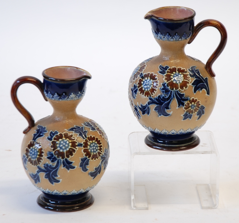 PAIR OF DOULTON SLATER'S PATENT POTTERY EWERS,  of footed bulbous form with scroll handles to the