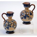 PAIR OF DOULTON SLATER'S PATENT POTTERY EWERS,  of footed bulbous form with scroll handles to the